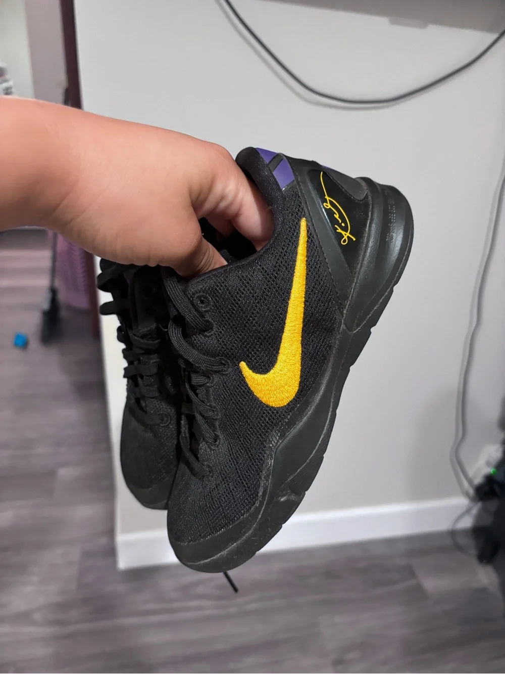 Nike Kids Black Sneakers with Gold Swoosh and Purple Heel